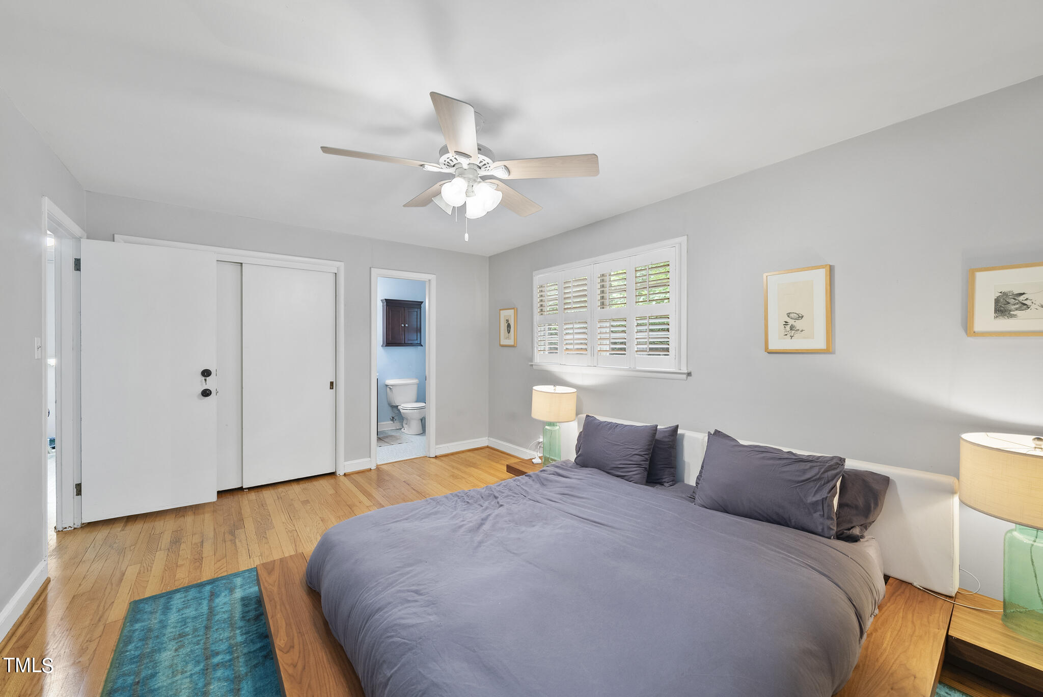 819 Beaver Dam Road Raleigh, NC 27607 - Photo 14 of 28 a bedroom with a large bed and a chandelier