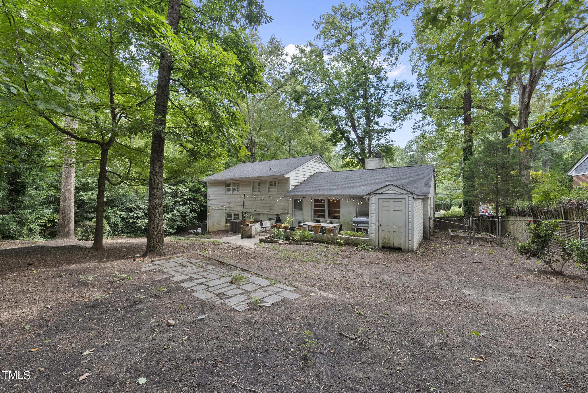 819 Beaver Dam Road Raleigh, NC 27607 - Photo 23 of 28 a view of a house with large trees and wooden fence
