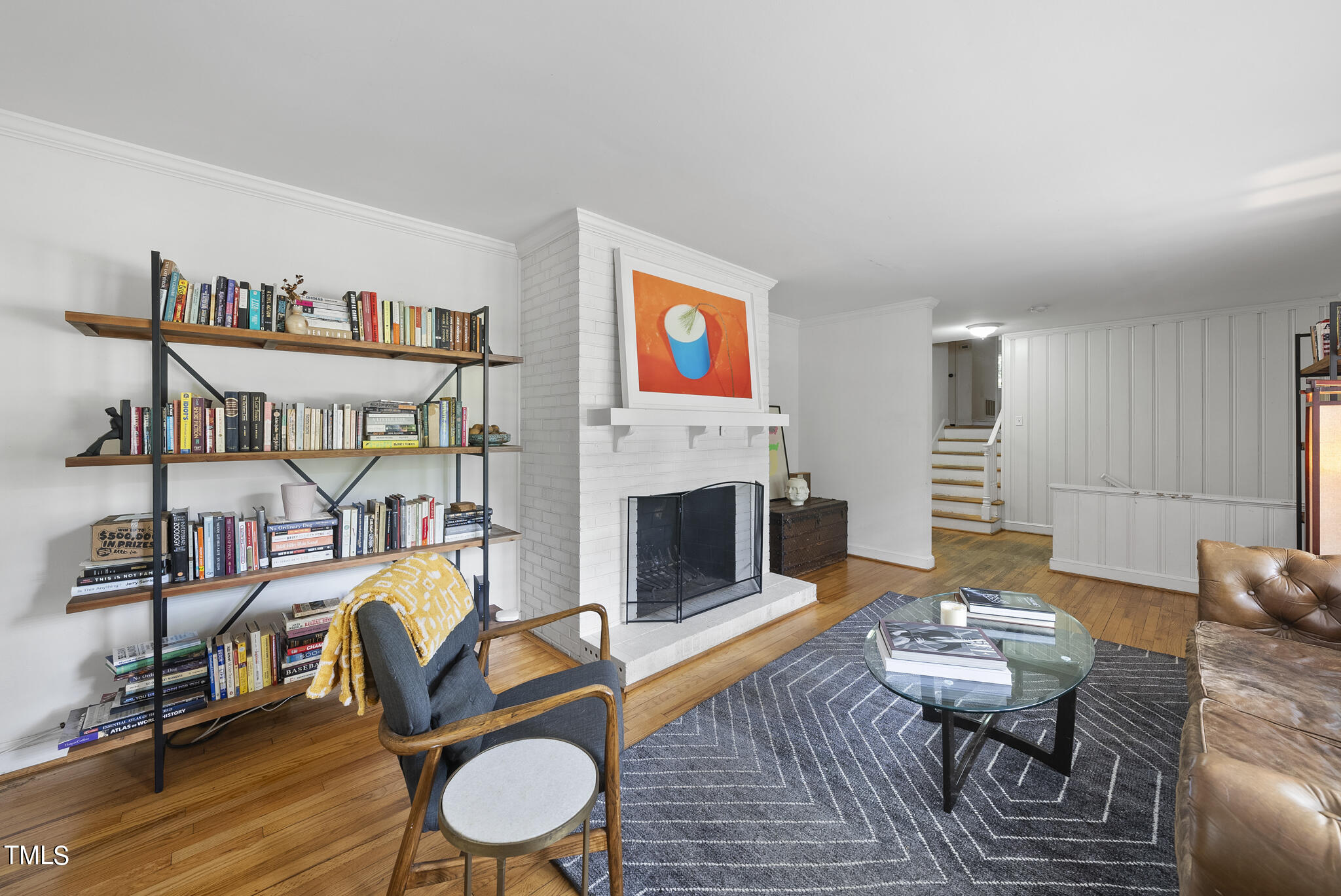 819 Beaver Dam Road Raleigh, NC 27607 - Photo 3 of 28 a living room with furniture a fireplace and a table
