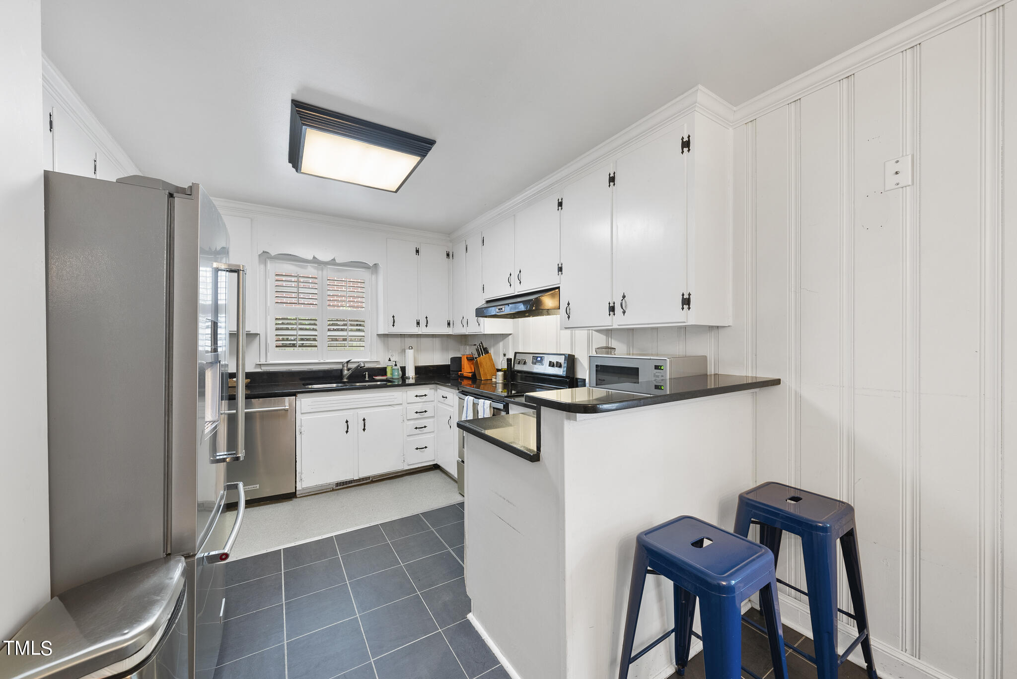 819 Beaver Dam Road Raleigh, NC 27607 - Photo 6 of 28 a kitchen with stainless steel appliances a refrigerator sink and cabinets
