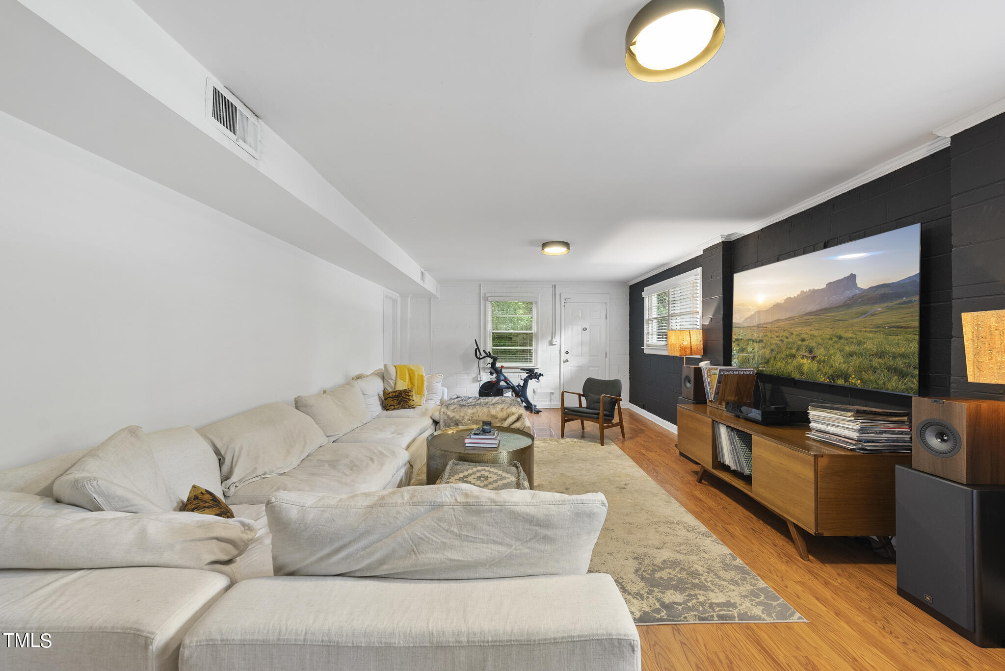 819 Beaver Dam Road Raleigh, NC 27607 - Photo 9 of 28 a living room with furniture and a flat screen tv
