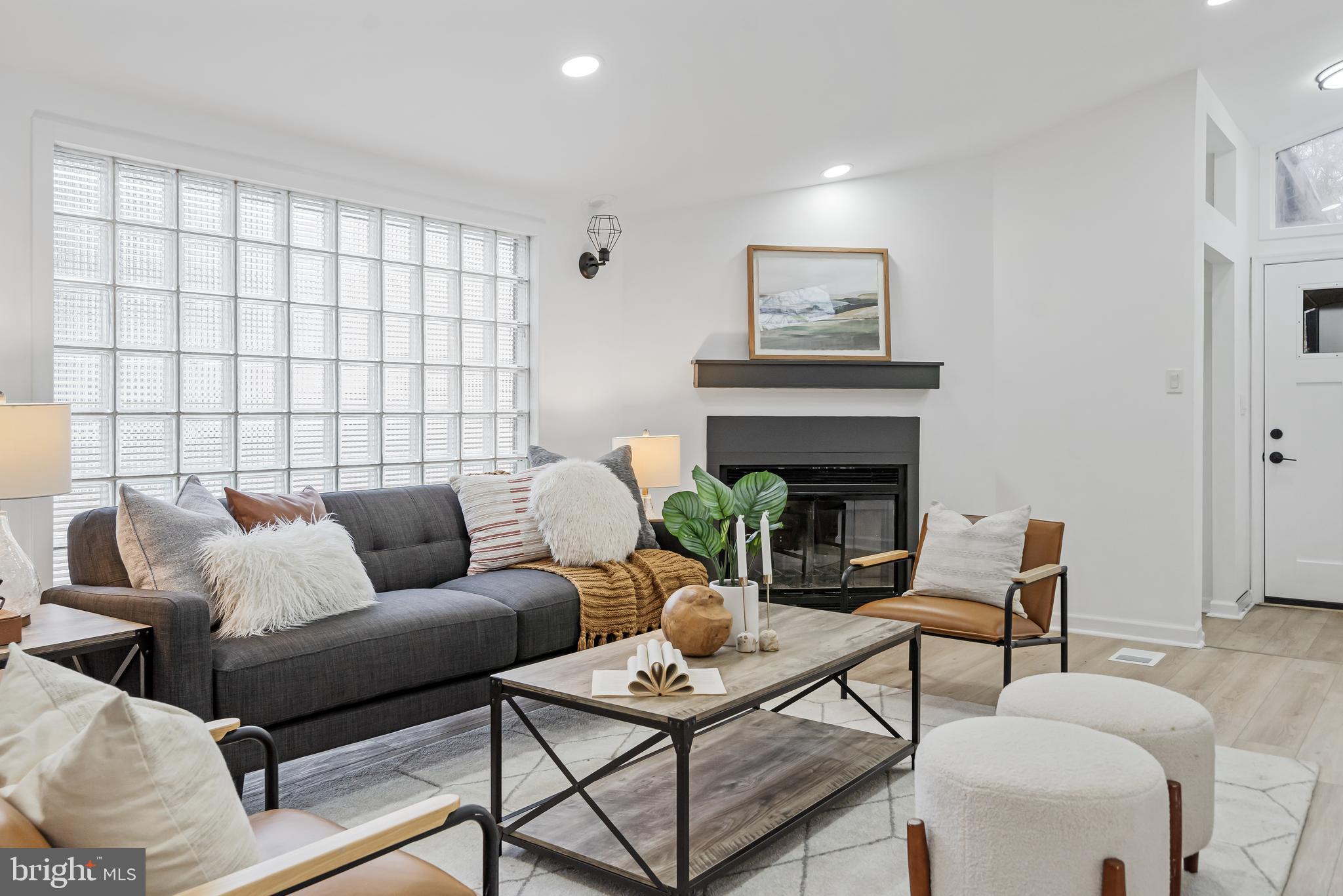 6136 Sinbad Place Columbia, MD 21045 - Photo 2 of 31 a living room with furniture and a fireplace