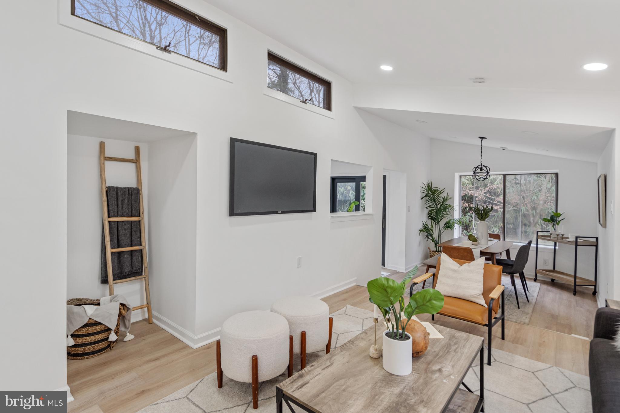 6136 Sinbad Place Columbia, MD 21045 - Photo 3 of 31 a living room with furniture a flat screen tv and a potted plant