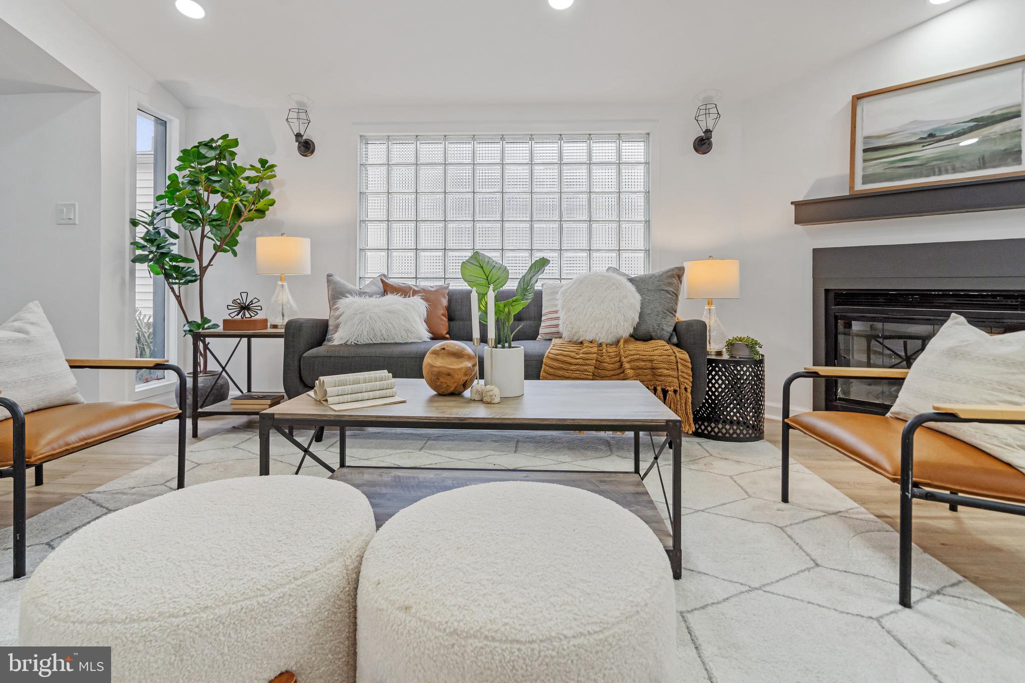6136 Sinbad Place Columbia, MD 21045 - Photo 10 of 31 a living room with furniture a potted plant and a fireplace