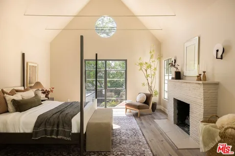 a bedroom with two beds and a fireplace