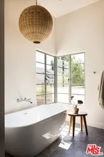 a living room with a table and a potted plant
