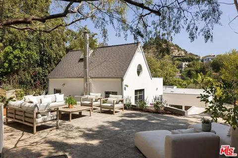 a building outdoor space with patio furniture and potted plants
