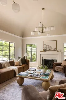 a living room with furniture fireplace and window