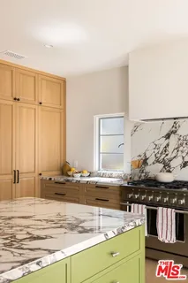 a view of a kitchen with stainless steel appliances granite countertop a stove and a sink