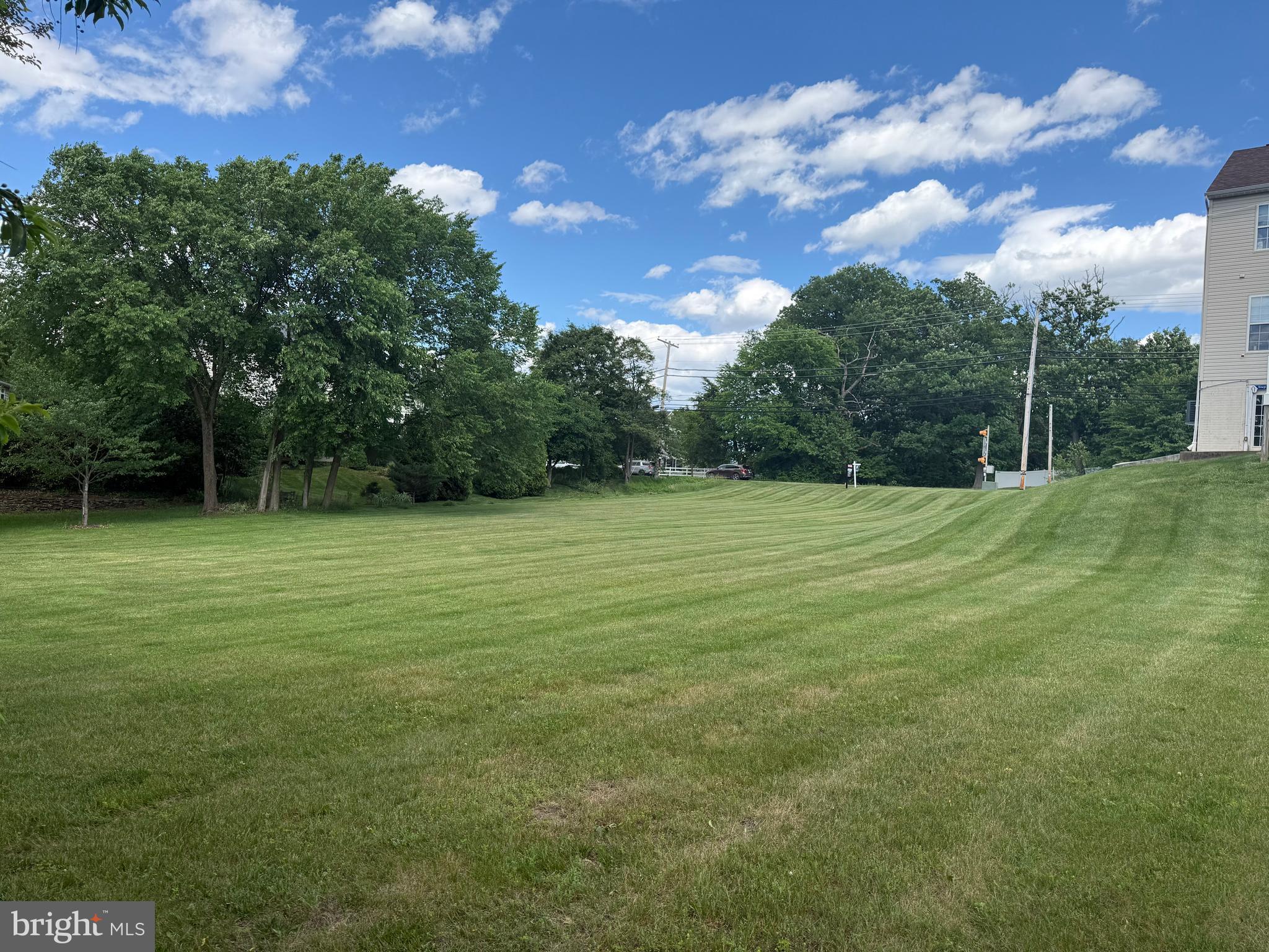 4996 Ilchester Road Ellicott City, MD 21043 - Photo 5 of 74 a view of a green field with wooden fence