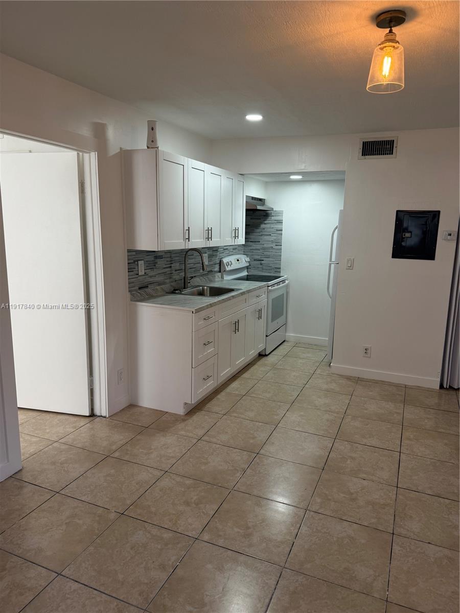4301 Northwest 19th Street, Unit 7 Lauderhill, FL 33313 - Photo 4 of 12 a kitchen with stainless steel appliances granite countertop a refrigerator and a sink