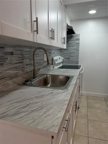 a kitchen with a sink and cabinets