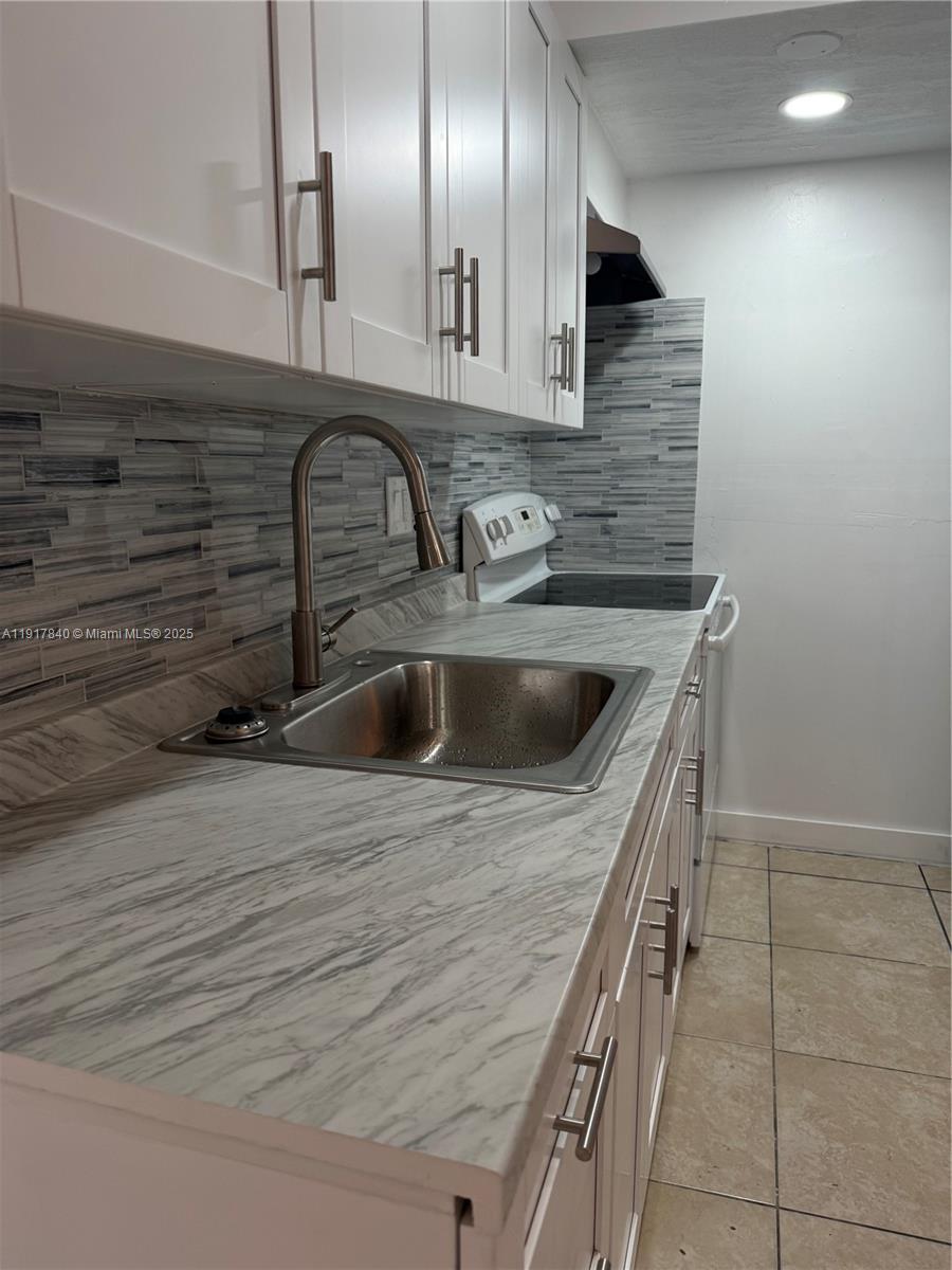 4301 Northwest 19th Street, Unit 7 Lauderhill, FL 33313 - Photo 6 of 12 a kitchen with a sink and cabinets