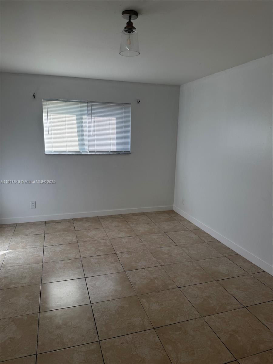 4301 Northwest 19th Street, Unit 7 Lauderhill, FL 33313 - Photo 8 of 12 a view of an empty room with a window