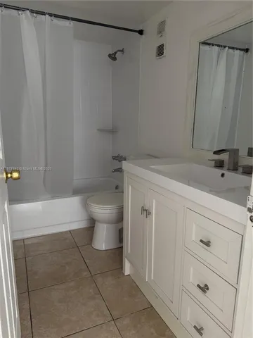 a bathroom with a sink a toilet and a shower