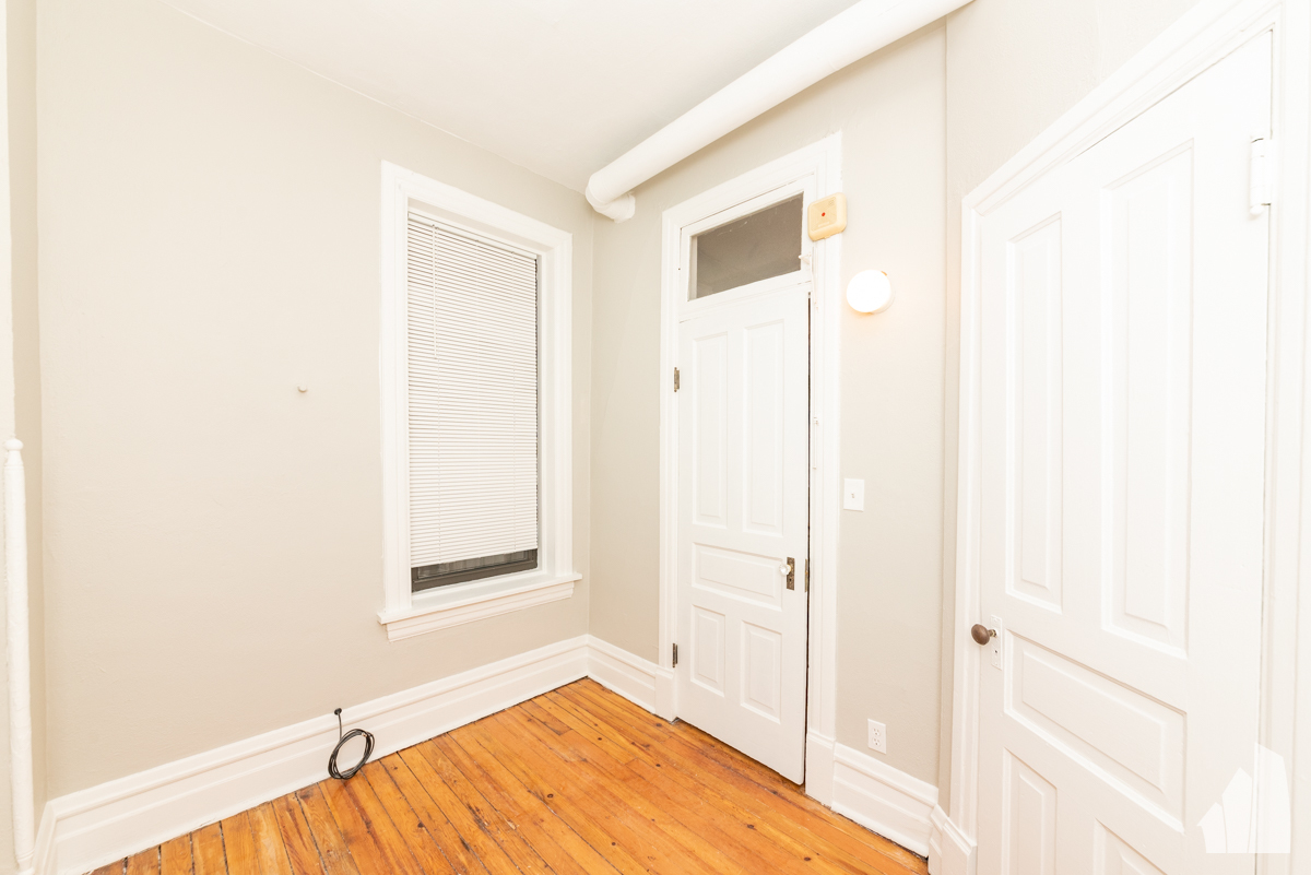 1420 West Irving Park Road, Unit 3 Chicago, IL 60613 - Photo 14 of 21 a view of a livingroom with wooden floor and a bathroom