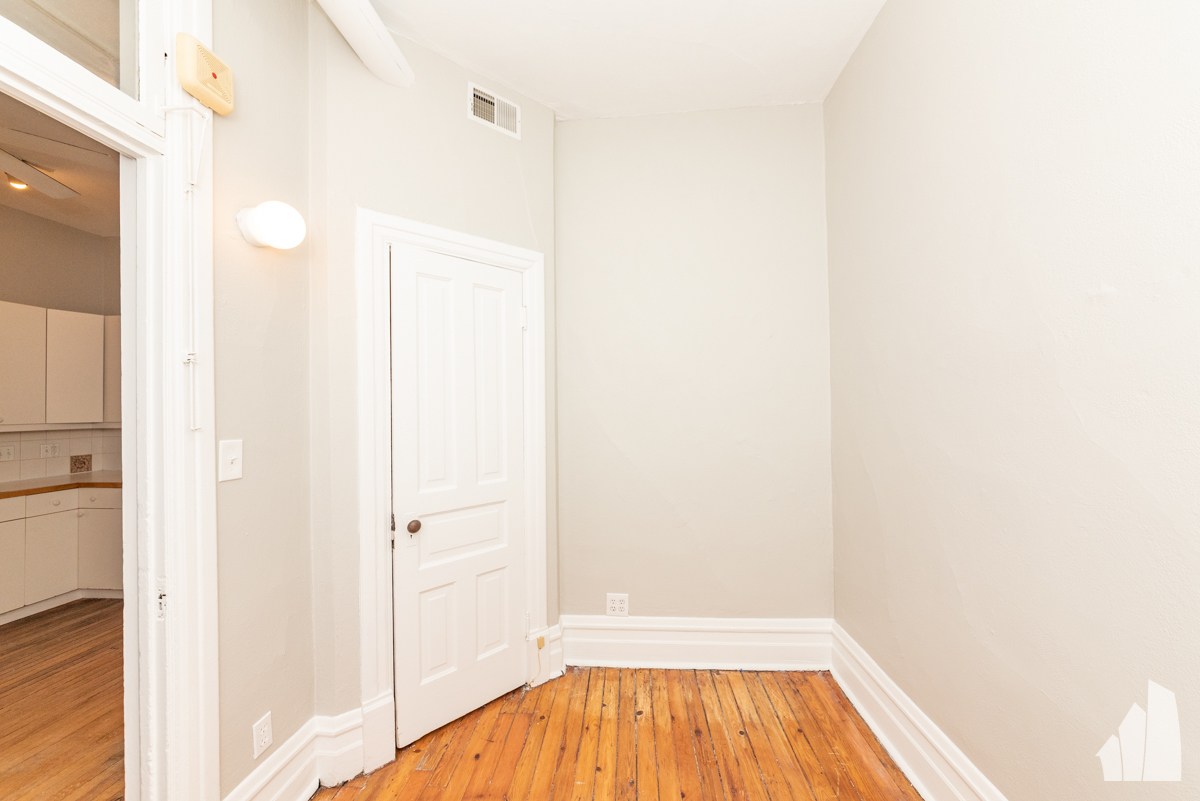 1420 West Irving Park Road, Unit 3 Chicago, IL 60613 - Photo 17 of 21 a view of a room with wooden floor and a bathroom