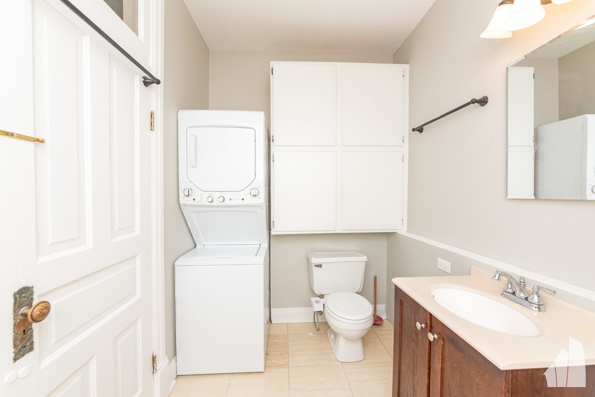1420 West Irving Park Road, Unit 3 Chicago, IL 60613 - Photo 19 of 21 a white toilet sitting next to a bathroom sink