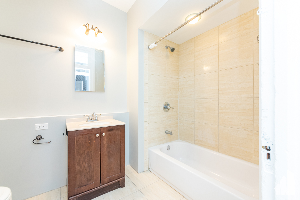 1420 West Irving Park Road, Unit 3 Chicago, IL 60613 - Photo 20 of 21 a bathroom with a tub a sink and a shower