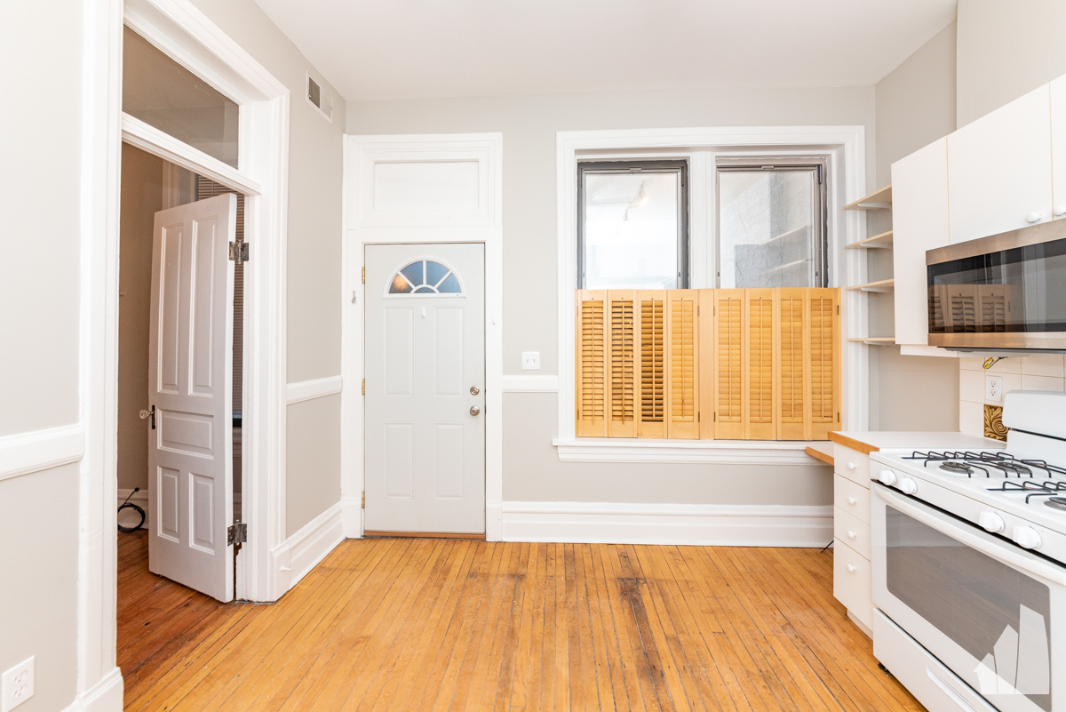 1420 West Irving Park Road, Unit 3 Chicago, IL 60613 - Photo 3 of 21 a view of a kitchen with wooden floor and electronic appliances