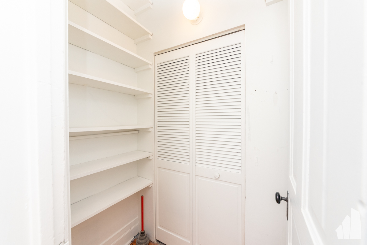 1420 West Irving Park Road, Unit 3 Chicago, IL 60613 - Photo 5 of 21 a view of a room with a white walls and a window