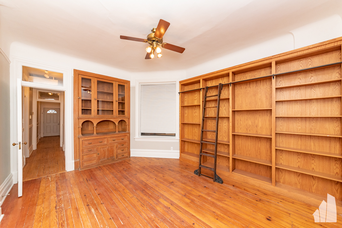 1420 West Irving Park Road, Unit 3 Chicago, IL 60613 - Photo 6 of 21 a view of a livingroom with wooden floor and a ceiling fan