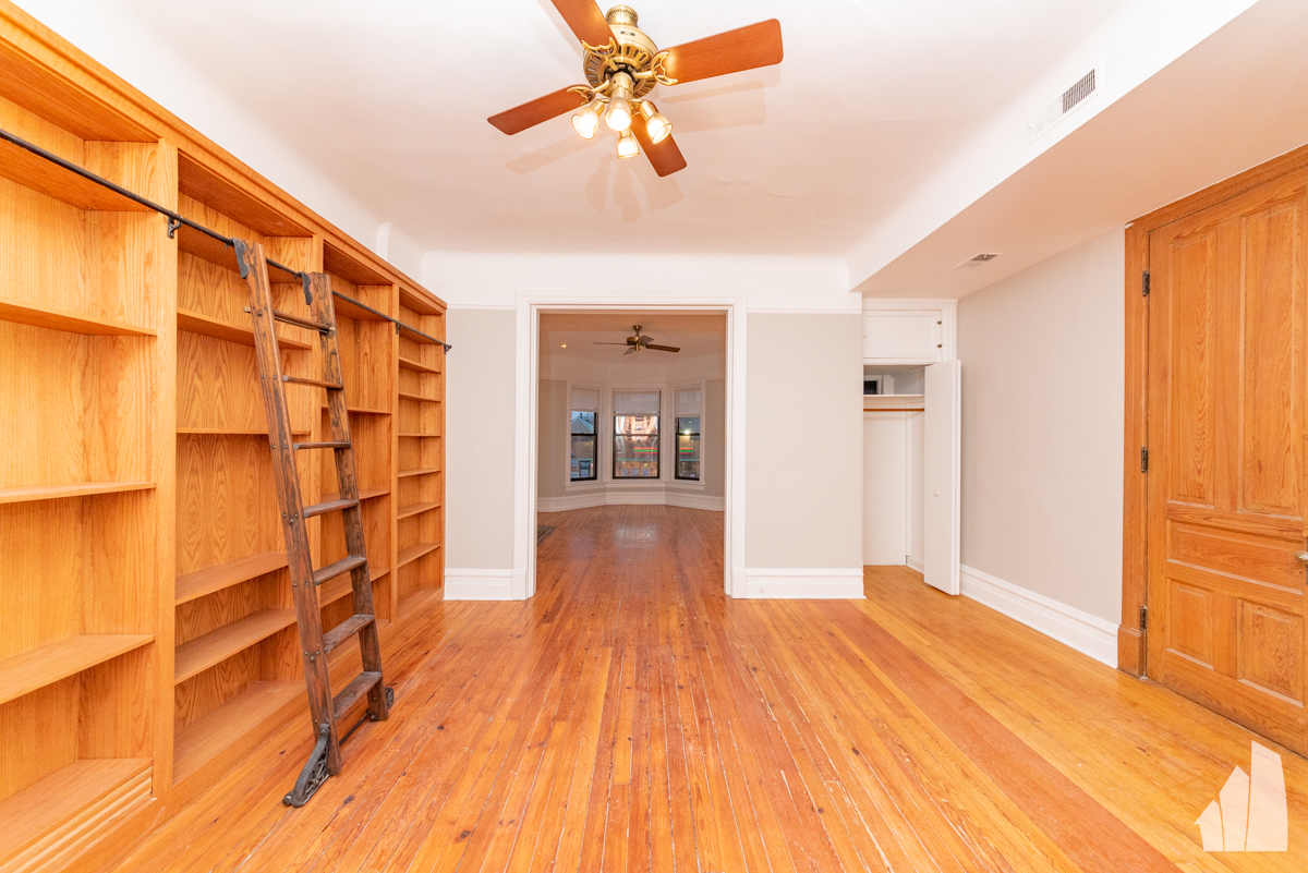 1420 West Irving Park Road, Unit 3 Chicago, IL 60613 - Photo 8 of 21 a view of empty room with wooden floor and fan