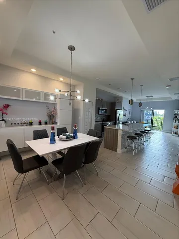 a kitchen with stainless steel appliances kitchen island granite countertop a sink and cabinets