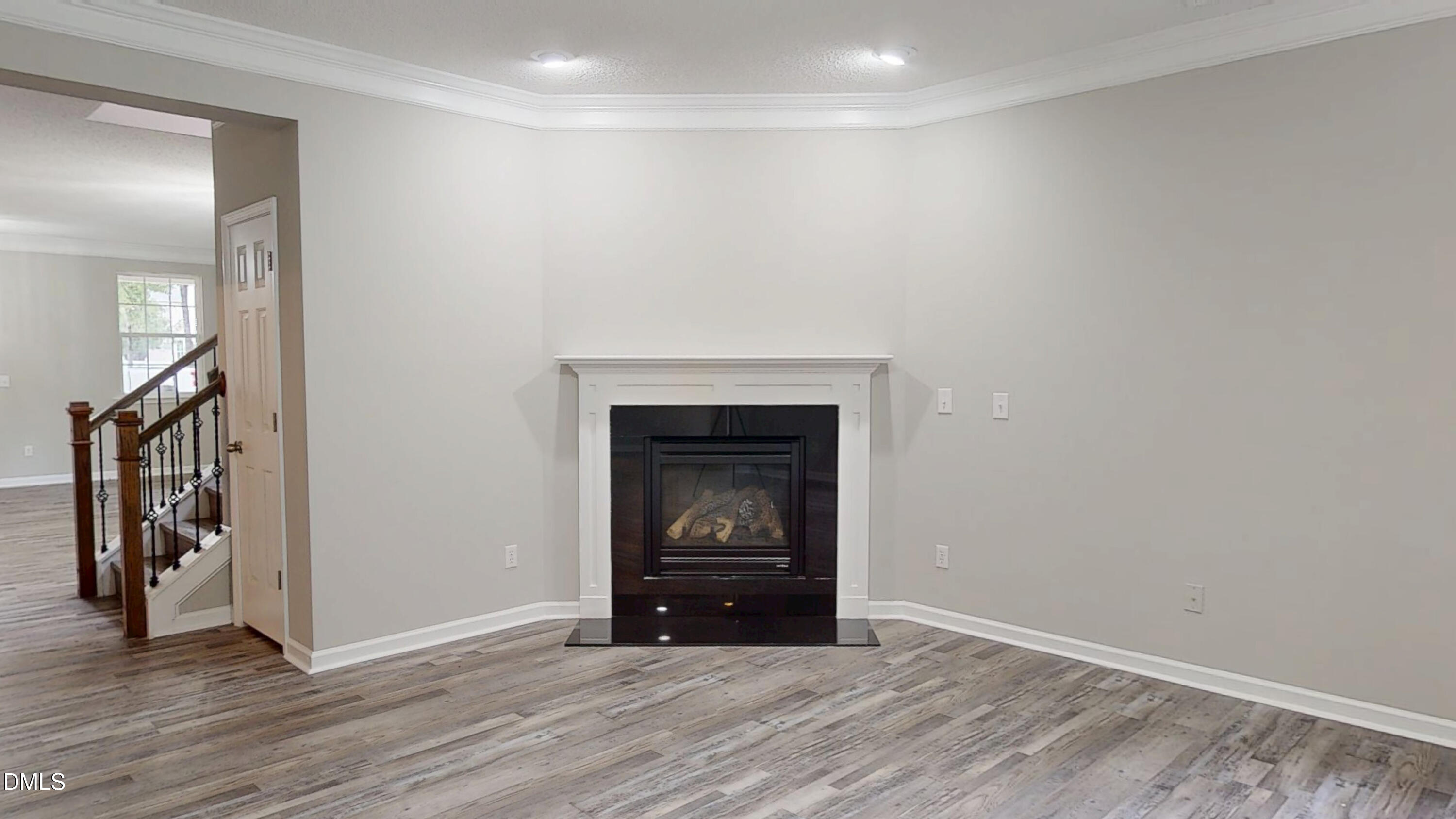 5708 Sea Fox Court Raleigh, NC 27616 - Photo 10 of 50 a view of an empty room with wooden floor and a window