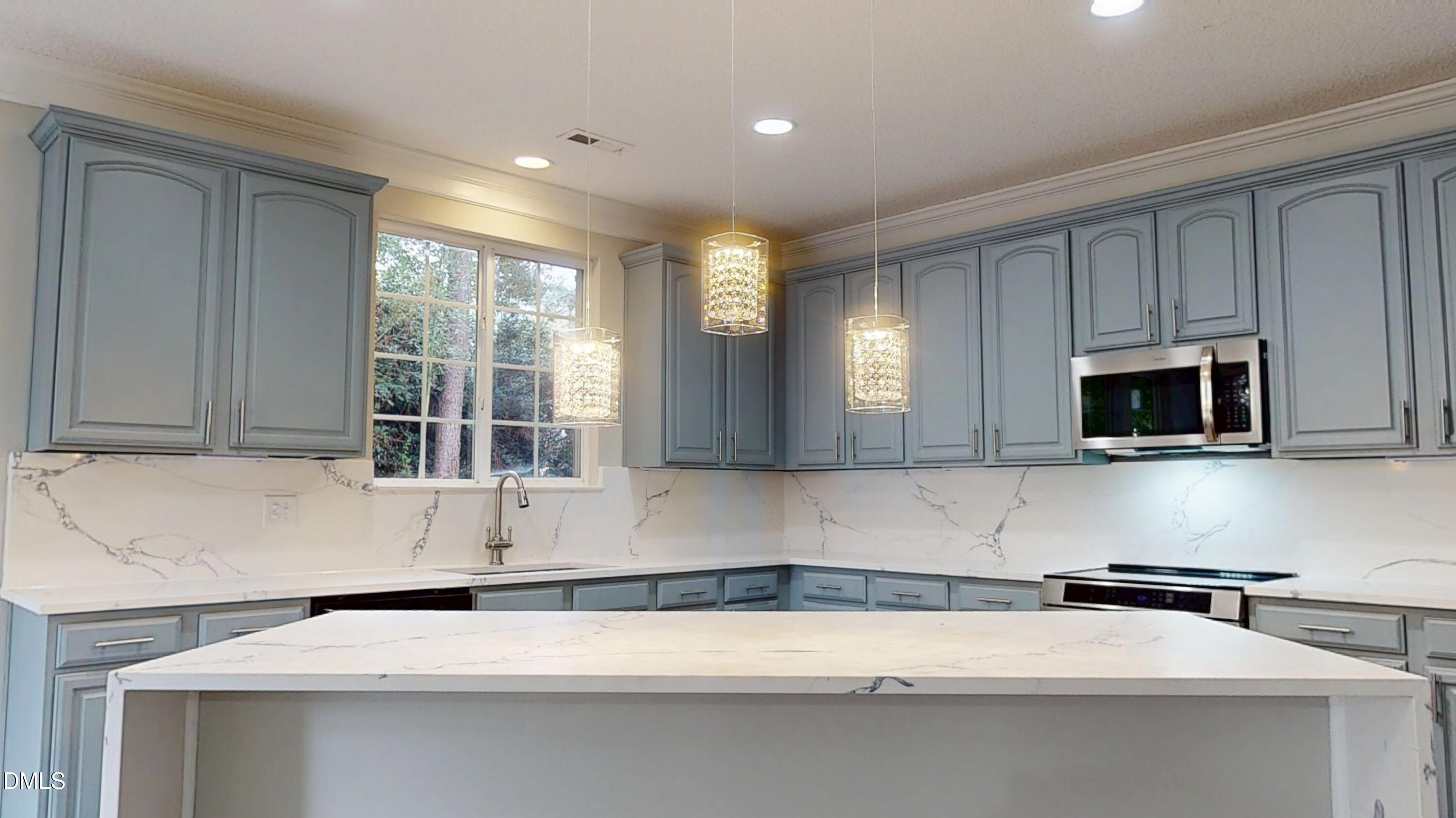 5708 Sea Fox Court Raleigh, NC 27616 - Photo 12 of 50 a kitchen with stainless steel appliances granite countertop a sink and a microwave