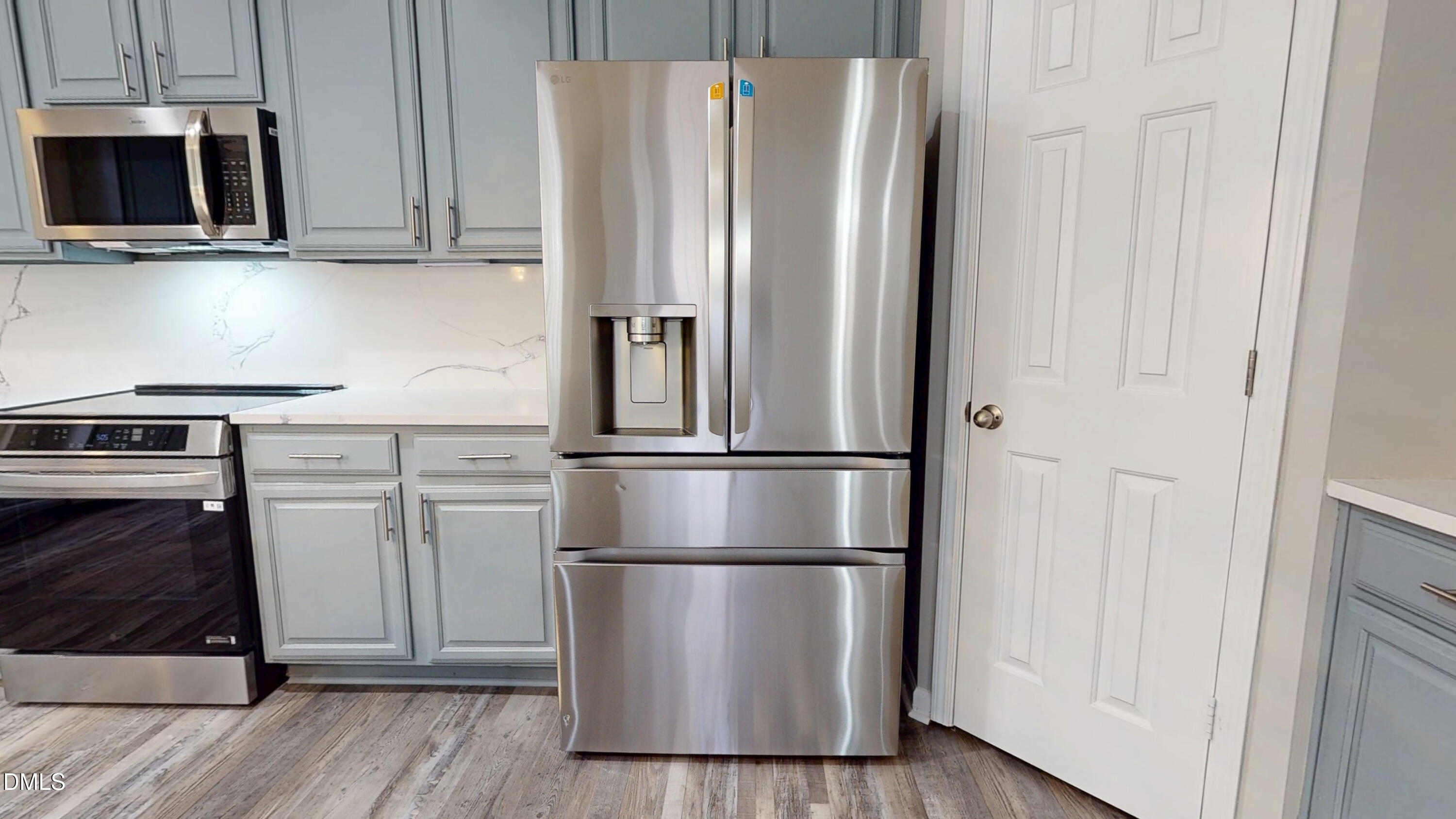 5708 Sea Fox Court Raleigh, NC 27616 - Photo 13 of 50 a metallic refrigerator freezer sitting in a kitchen