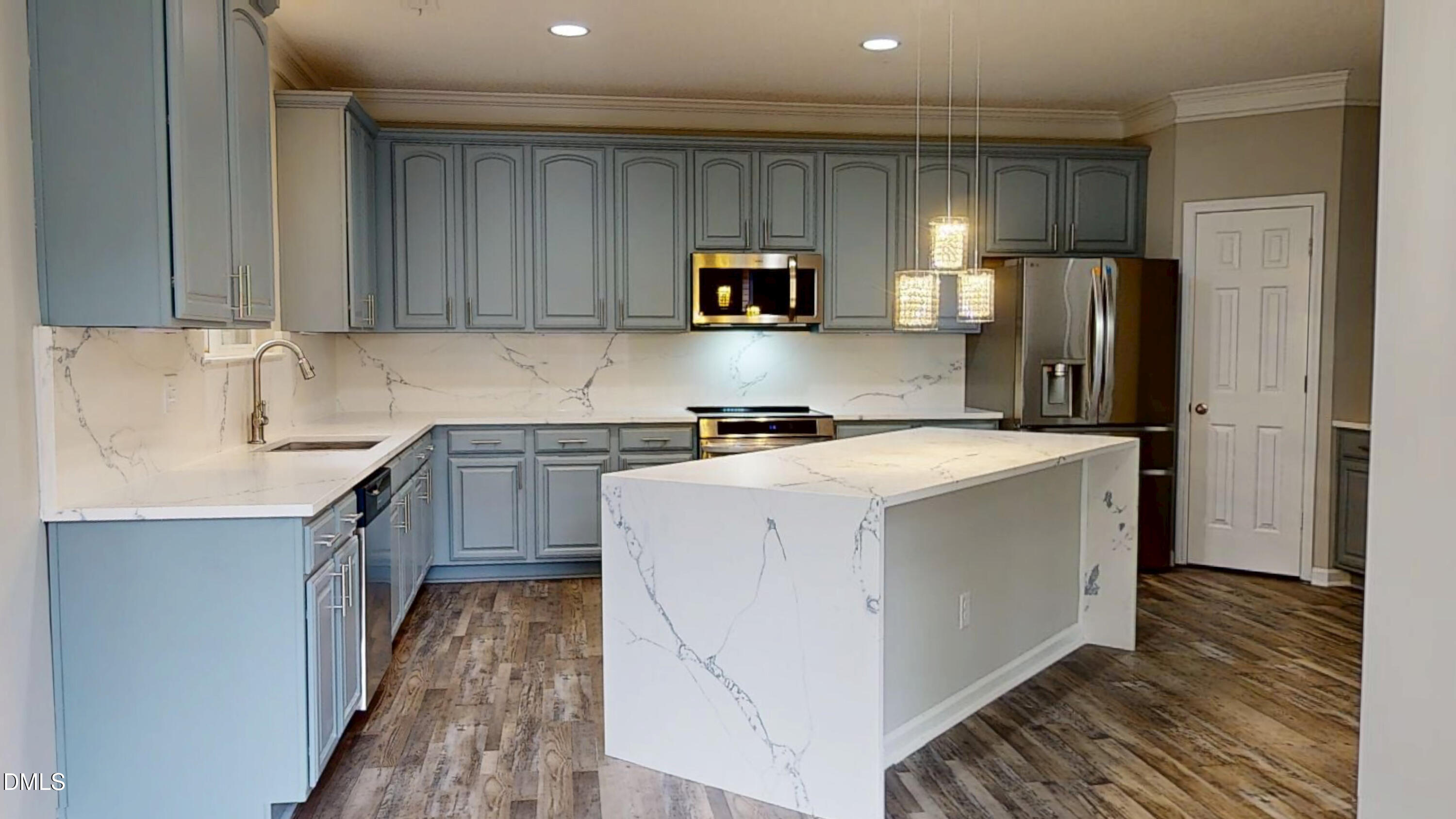 5708 Sea Fox Court Raleigh, NC 27616 - Photo 19 of 50 a kitchen with a sink a refrigerator and cabinets