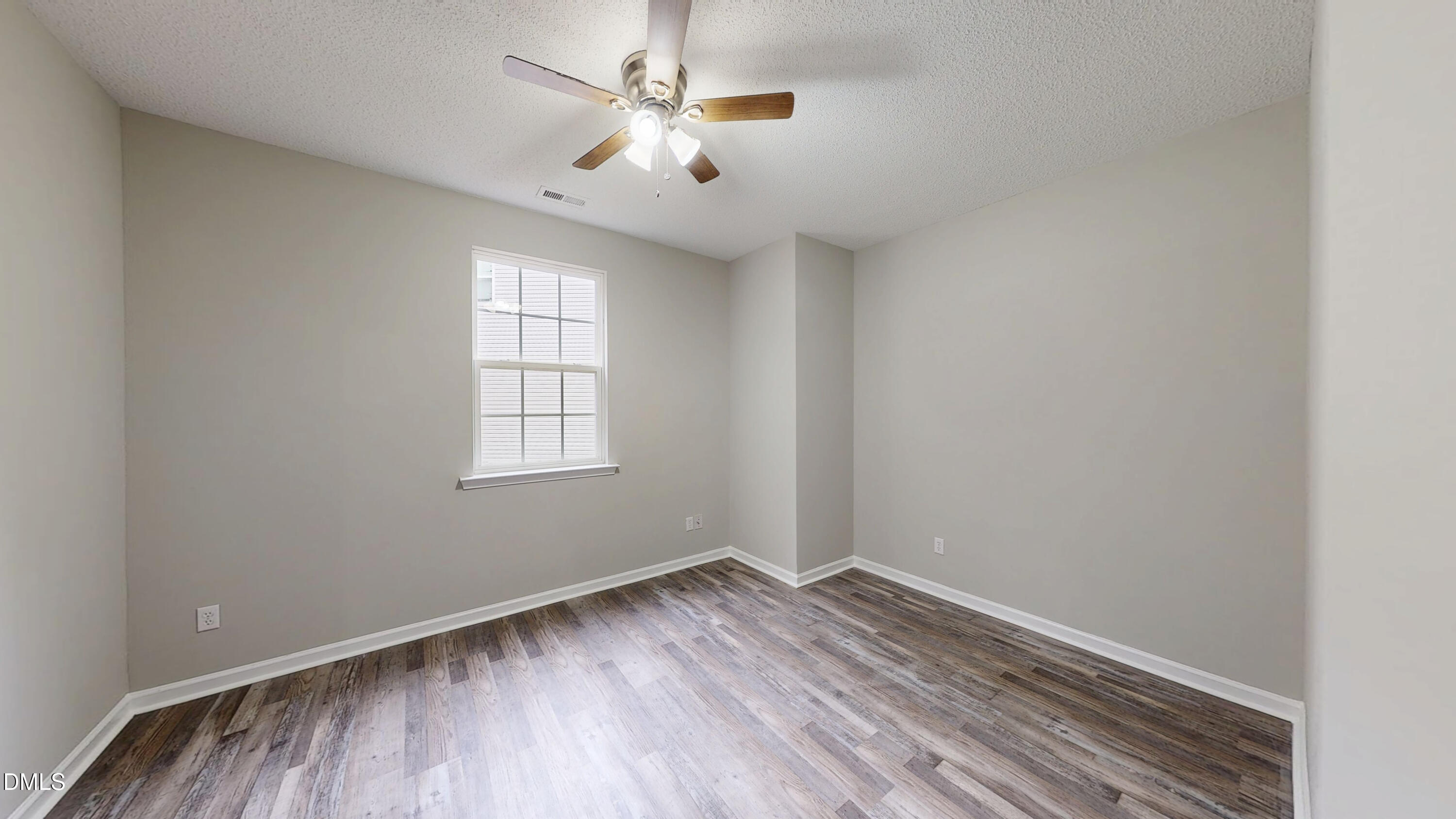 5708 Sea Fox Court Raleigh, NC 27616 - Photo 20 of 50 an empty room with wooden floor chandelier fan and windows