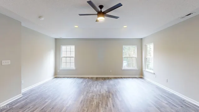 a view of hallway with wooden floor