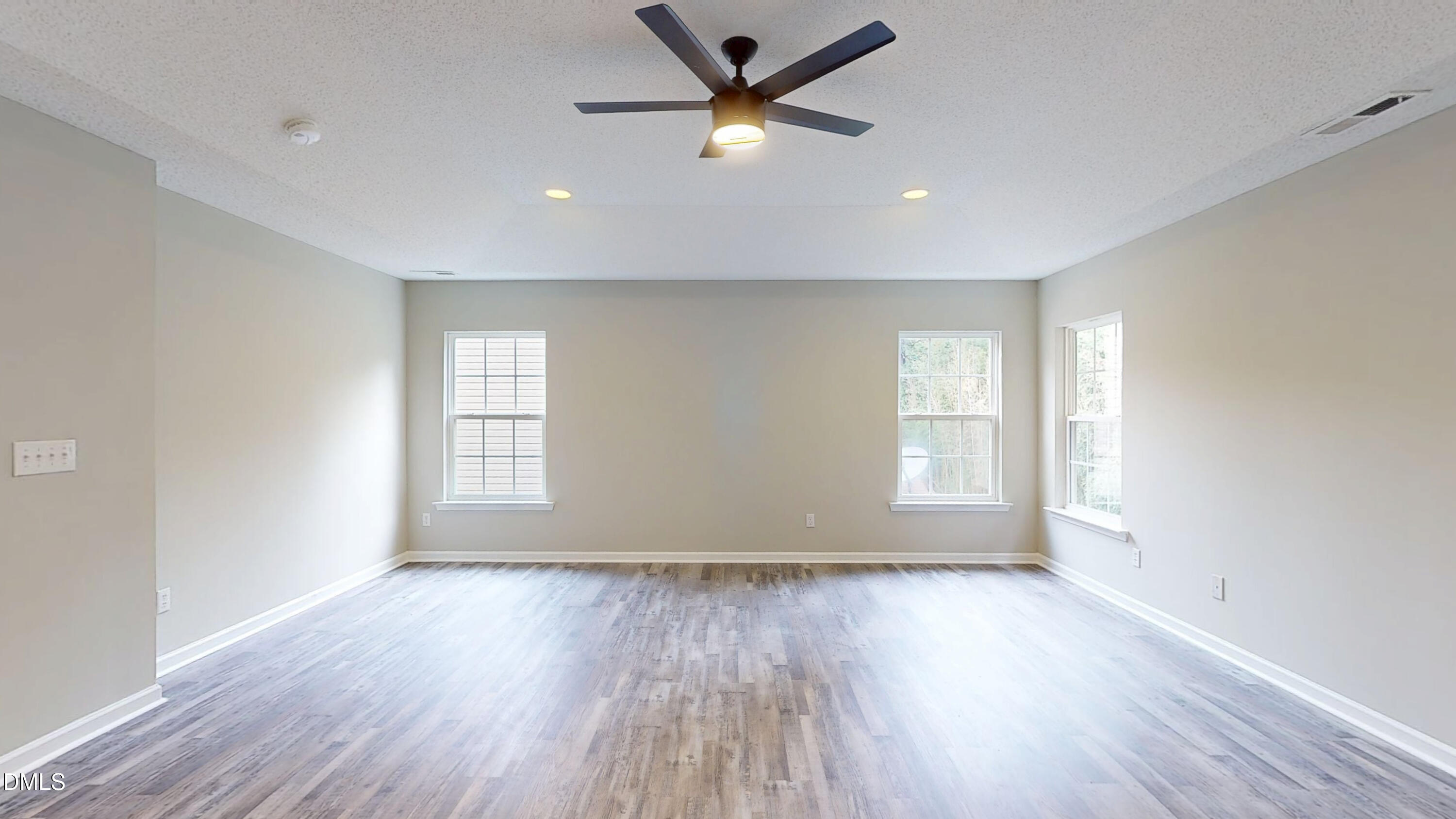 5708 Sea Fox Court Raleigh, NC 27616 - Photo 24 of 50 a view of empty room with wooden floor and fan