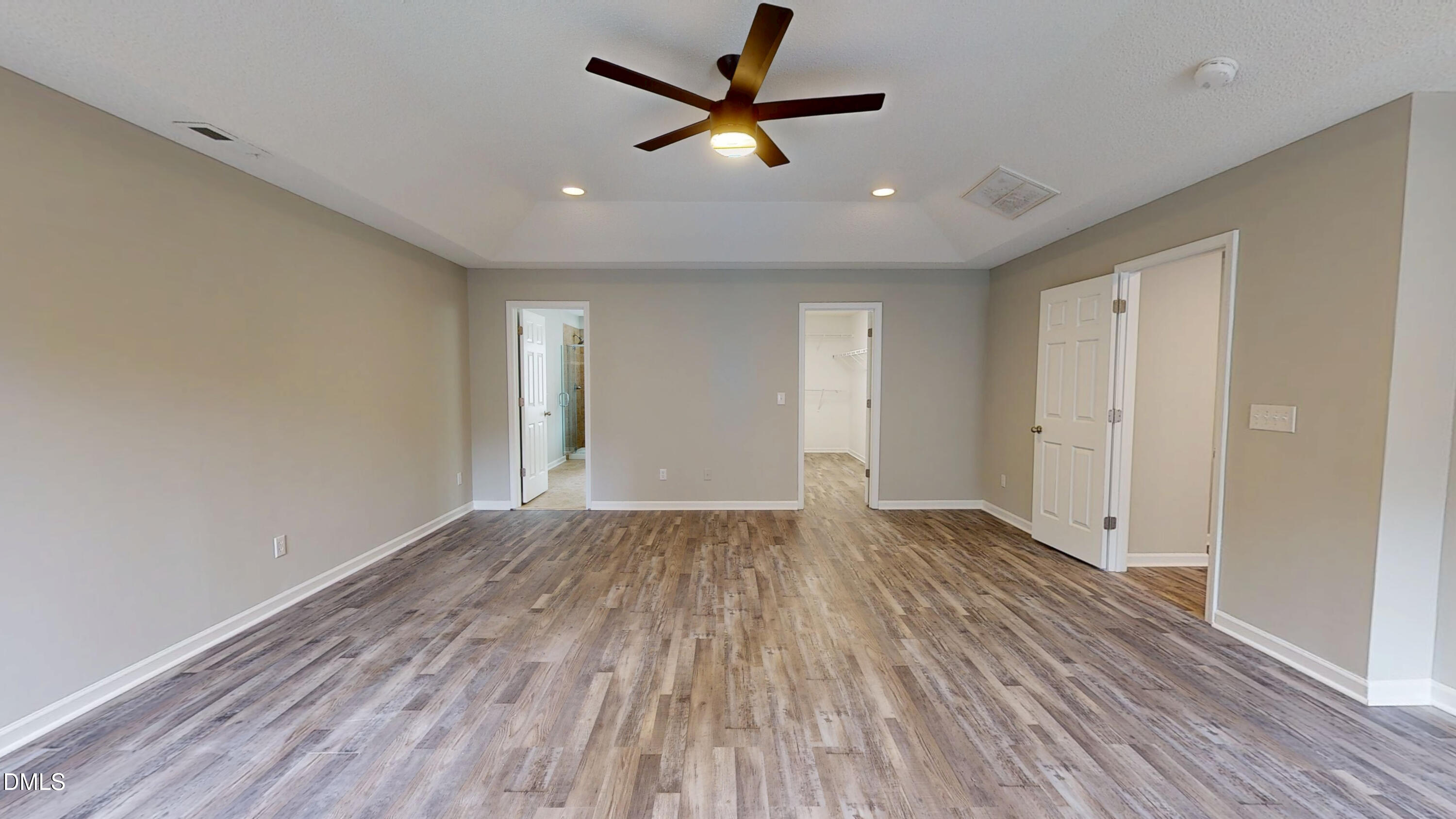 5708 Sea Fox Court Raleigh, NC 27616 - Photo 26 of 50 an empty room with wooden floor and a ceiling fan