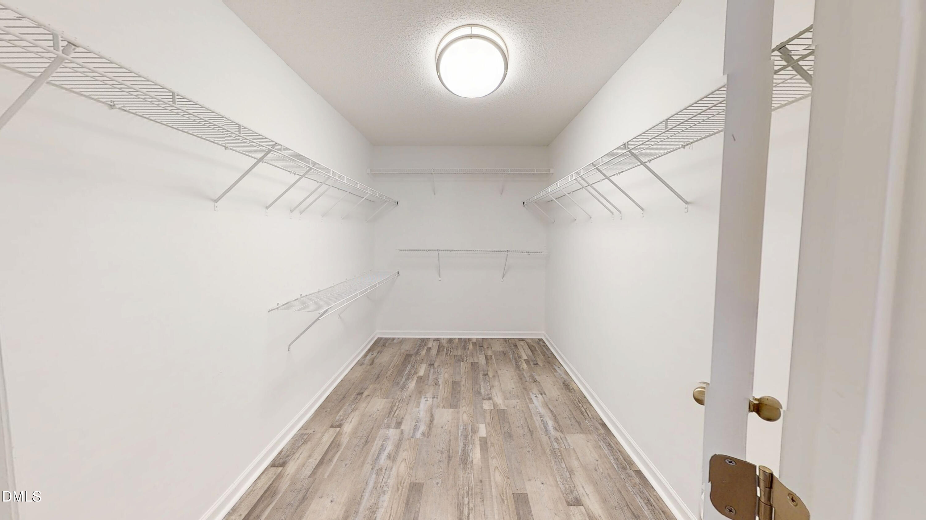 5708 Sea Fox Court Raleigh, NC 27616 - Photo 27 of 50 a view of a room with wooden floor and white walls