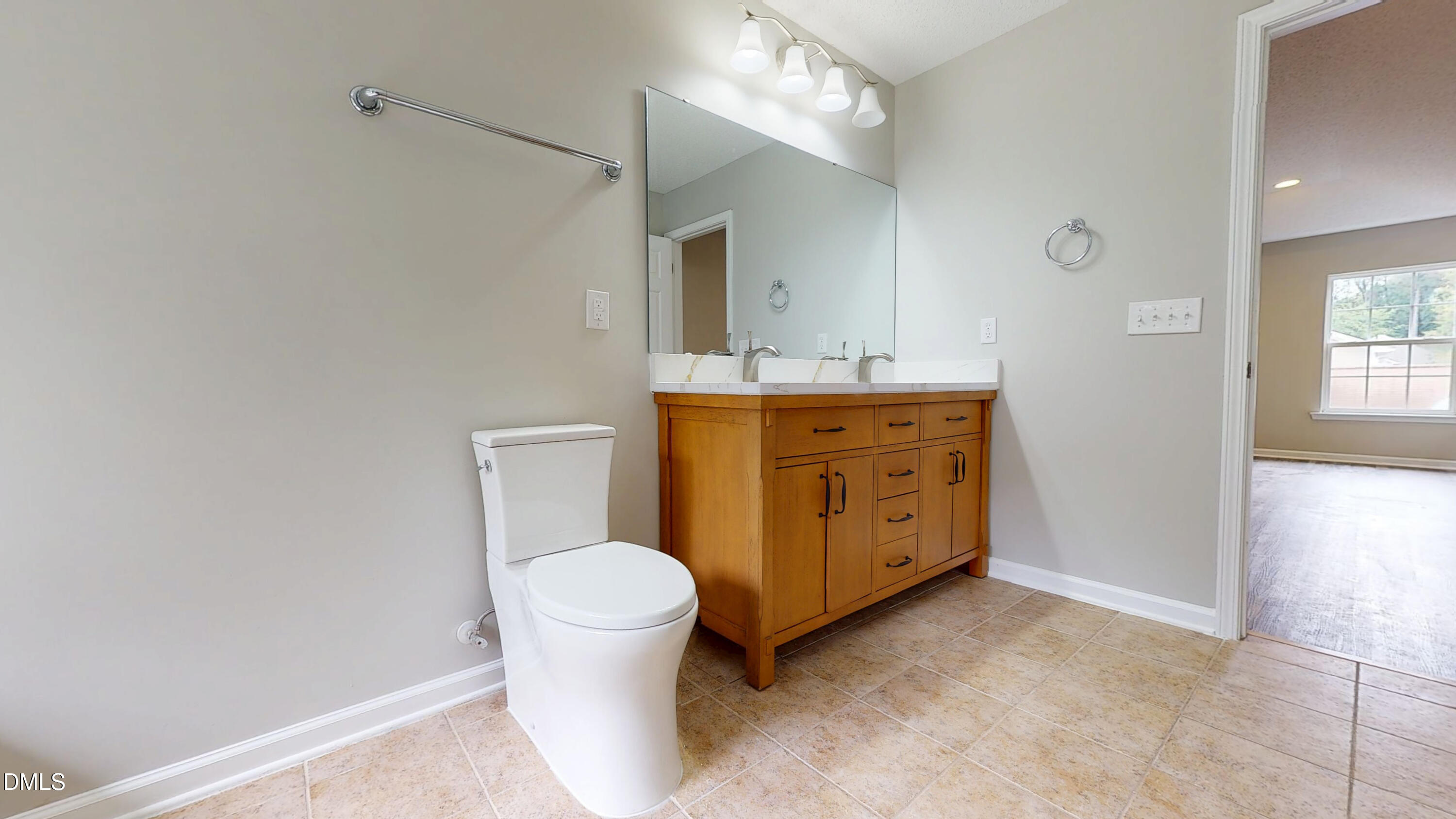 5708 Sea Fox Court Raleigh, NC 27616 - Photo 33 of 50 a spacious bathroom with a toilet sink and mirror