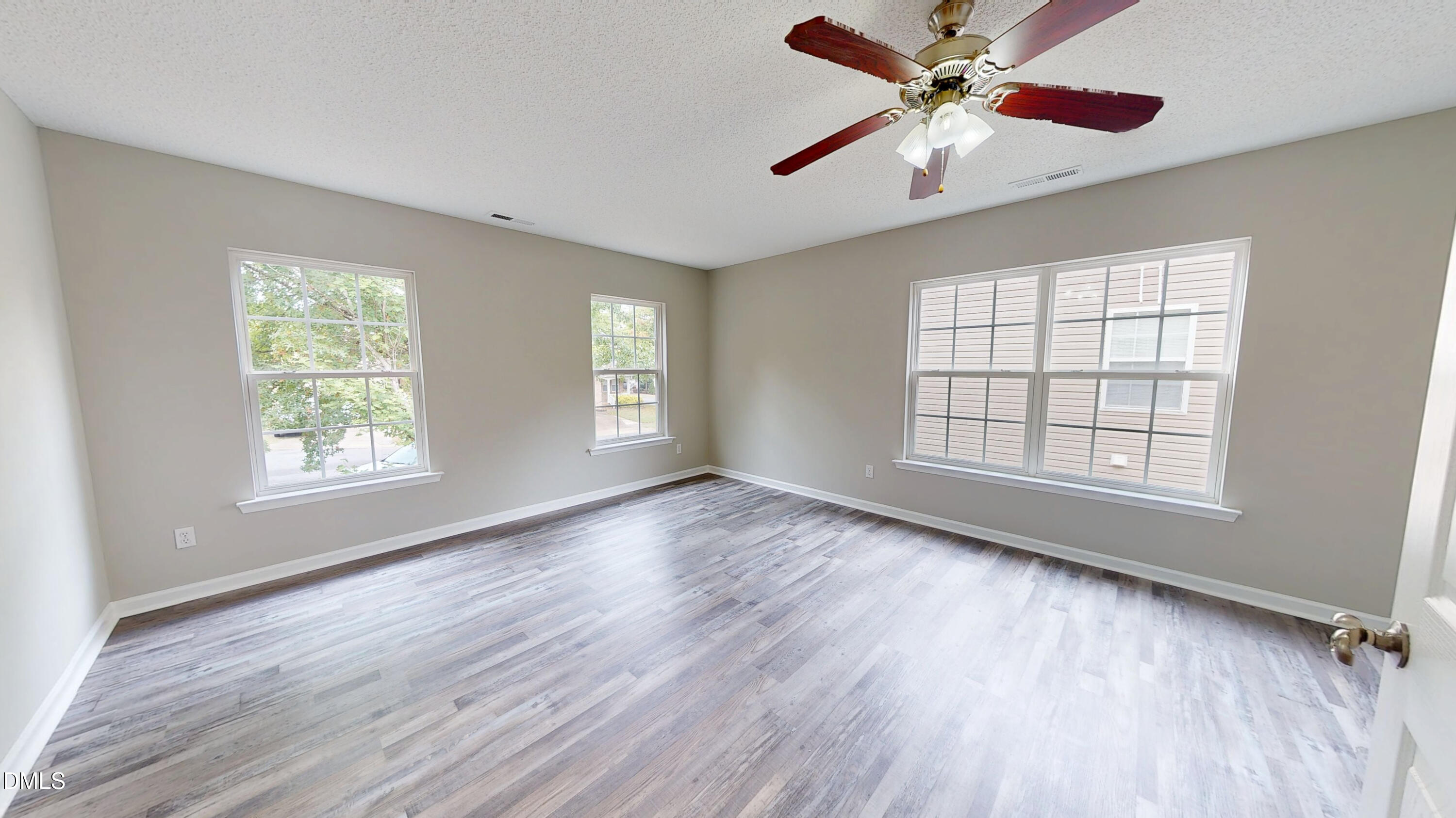 5708 Sea Fox Court Raleigh, NC 27616 - Photo 34 of 50 a view of an empty room with a window and wooden floor