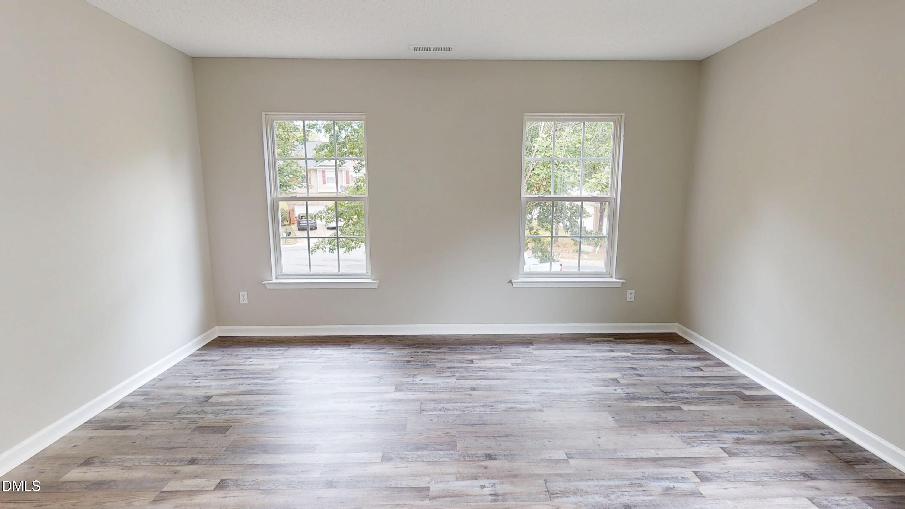 5708 Sea Fox Court Raleigh, NC 27616 - Photo 35 of 50 an empty room with wooden floor and windows