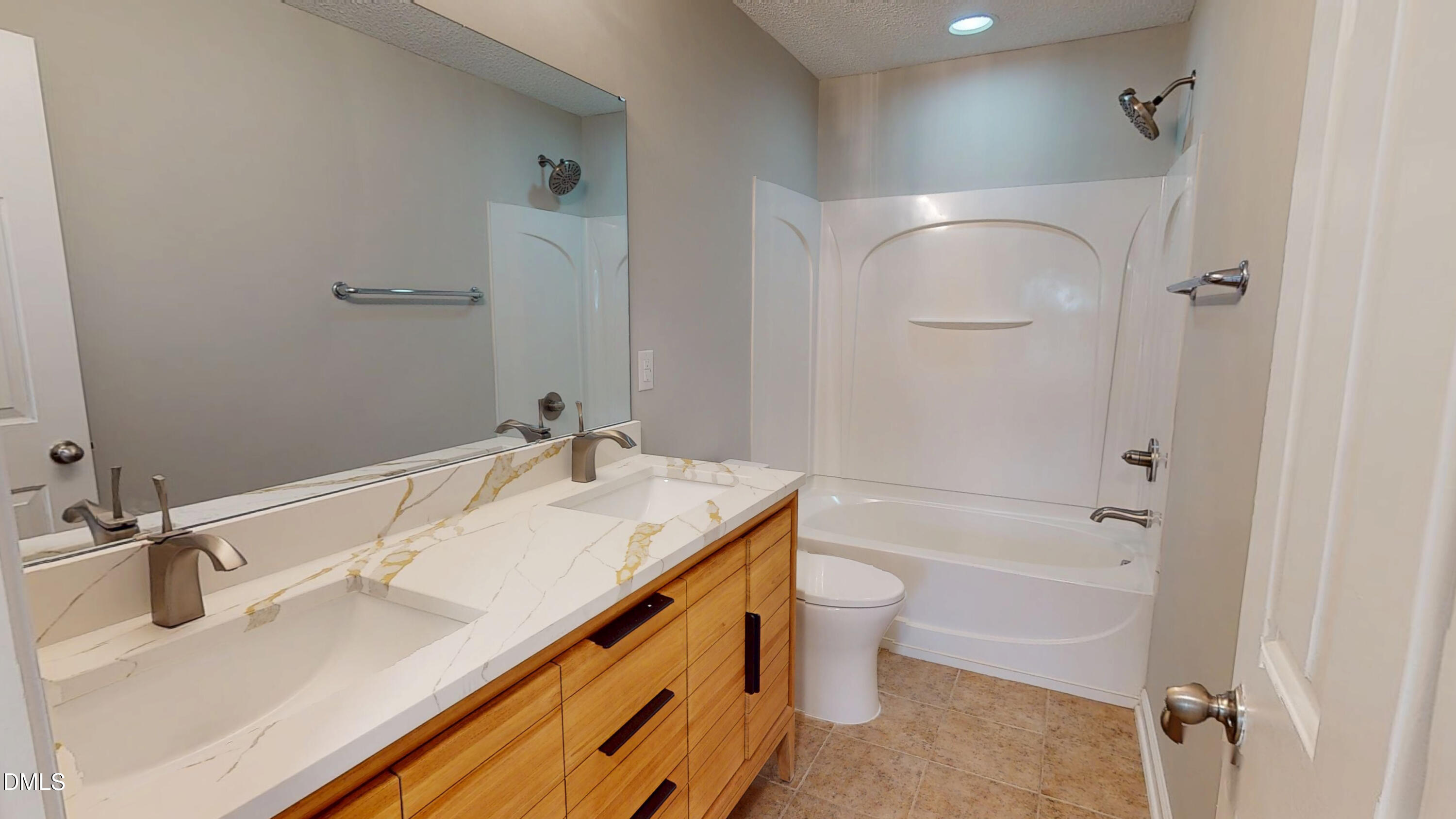 5708 Sea Fox Court Raleigh, NC 27616 - Photo 38 of 50 a bathroom with a granite countertop sink a toilet and shower