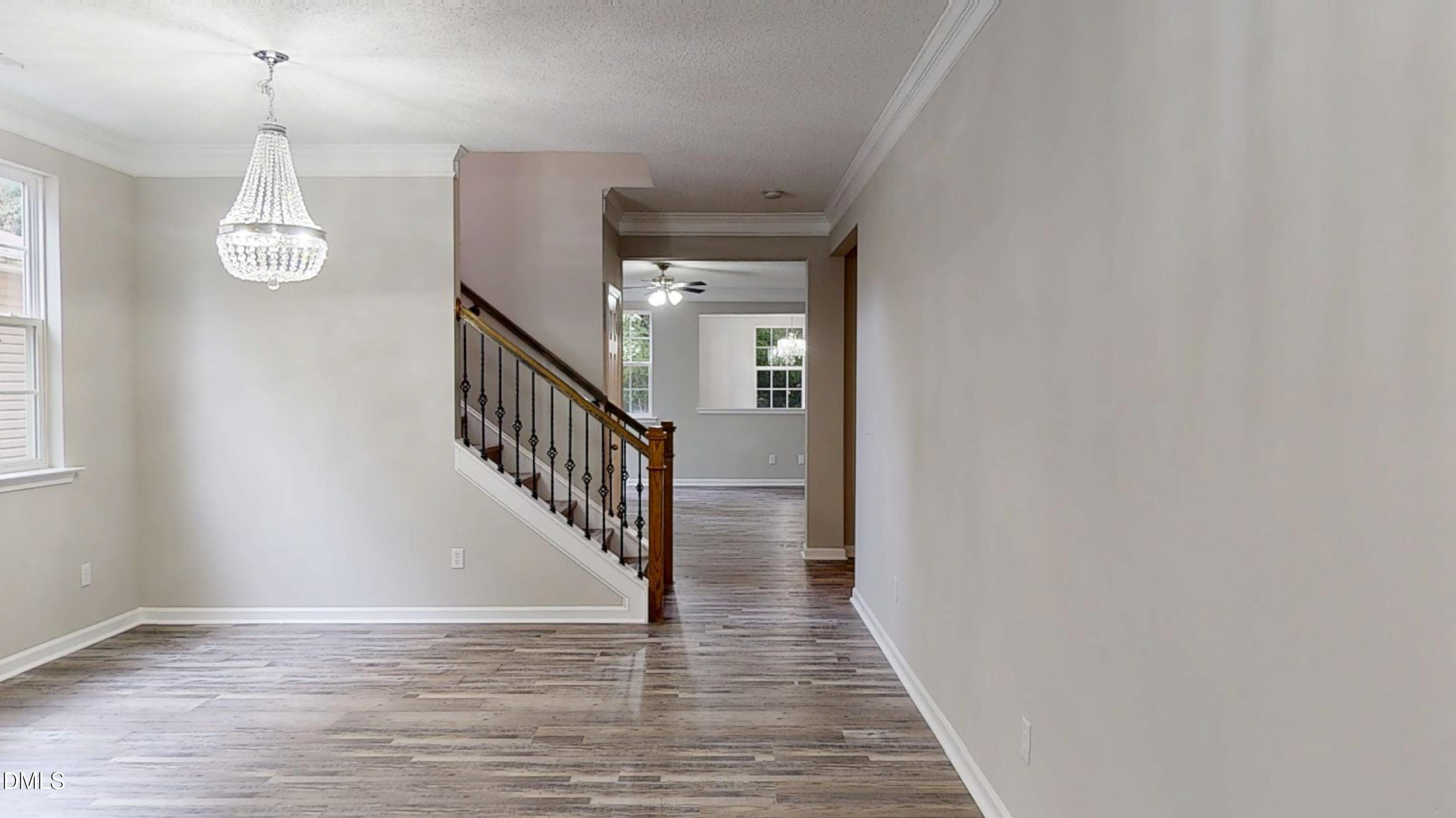 5708 Sea Fox Court Raleigh, NC 27616 - Photo 3 of 50 a view of a livingroom with wooden floor and stairs