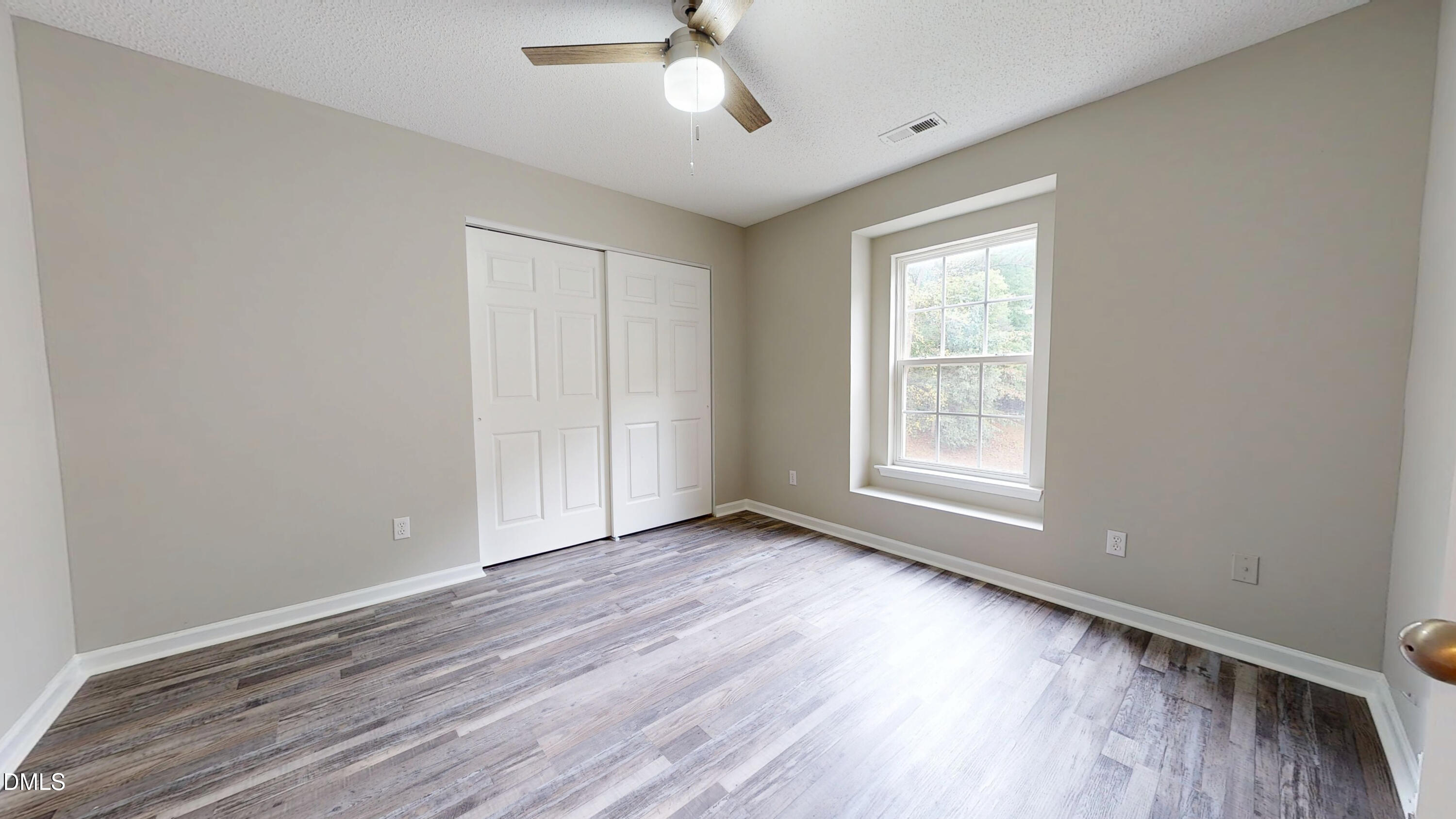 5708 Sea Fox Court Raleigh, NC 27616 - Photo 42 of 50 a view of an empty room with wooden floor and a window