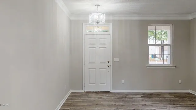 a view of a livingroom with wooden floor and stairs