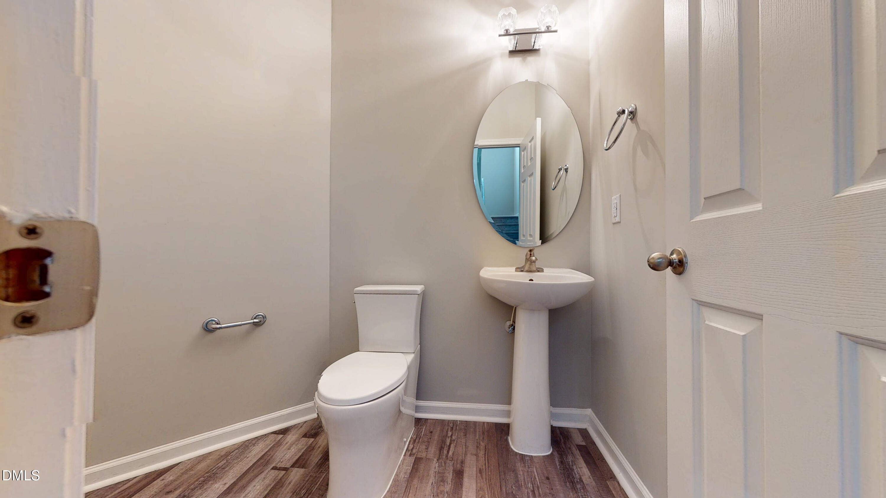 5708 Sea Fox Court Raleigh, NC 27616 - Photo 7 of 50 a bathroom with a toilet sink and mirror