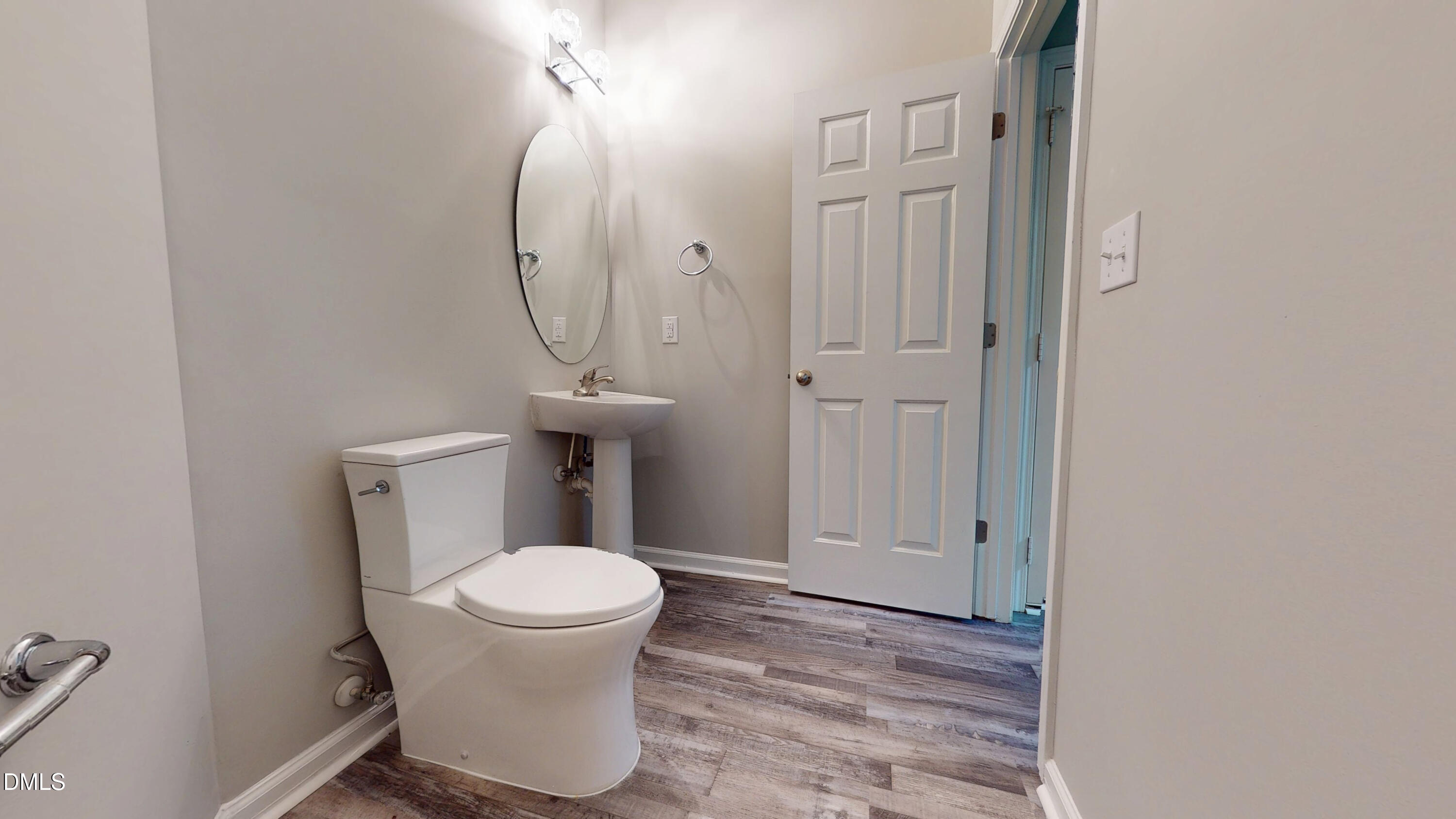 5708 Sea Fox Court Raleigh, NC 27616 - Photo 8 of 50 a bathroom with a toilet and a mirror