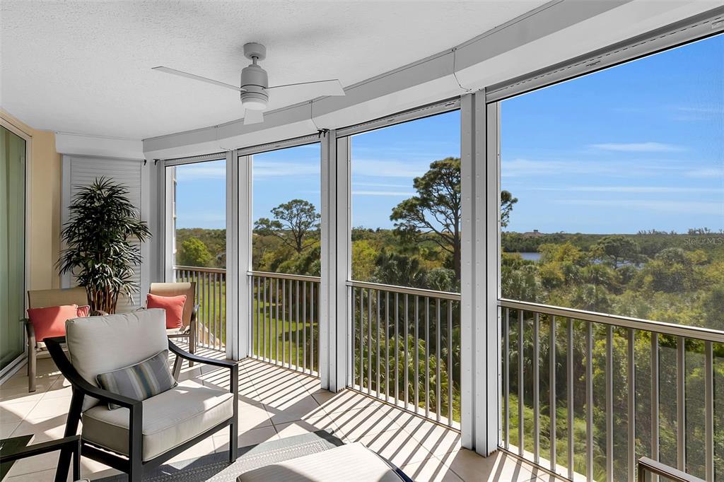 393 North Point Road, Unit 401 Osprey, FL 34229 - Photo 18 of 62 a balcony with wooden floor outdoor seating and furniture