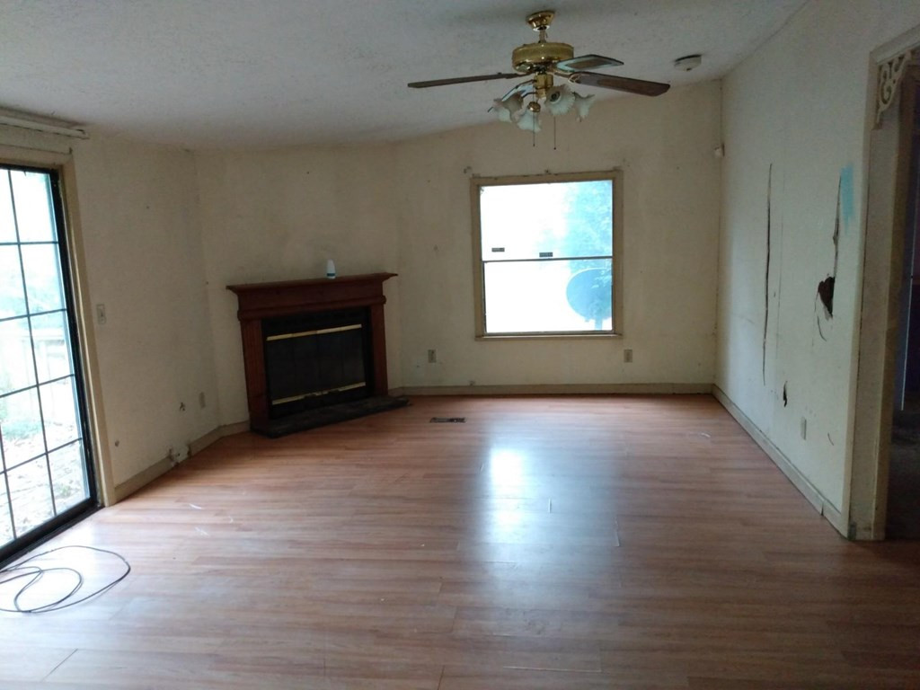 567 Cedar Road Aiken, SC 29803 - Photo 13 of 25 an empty room with windows chandelier and fireplace