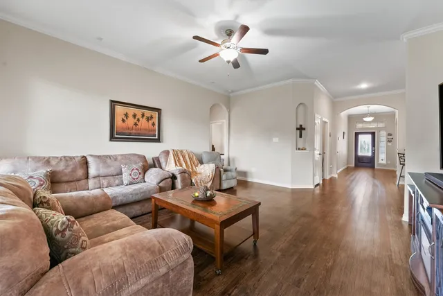 a living room with furniture and wooden floor