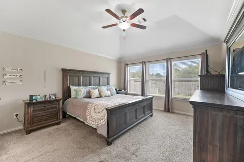 a spacious bedroom with a bed and a large window